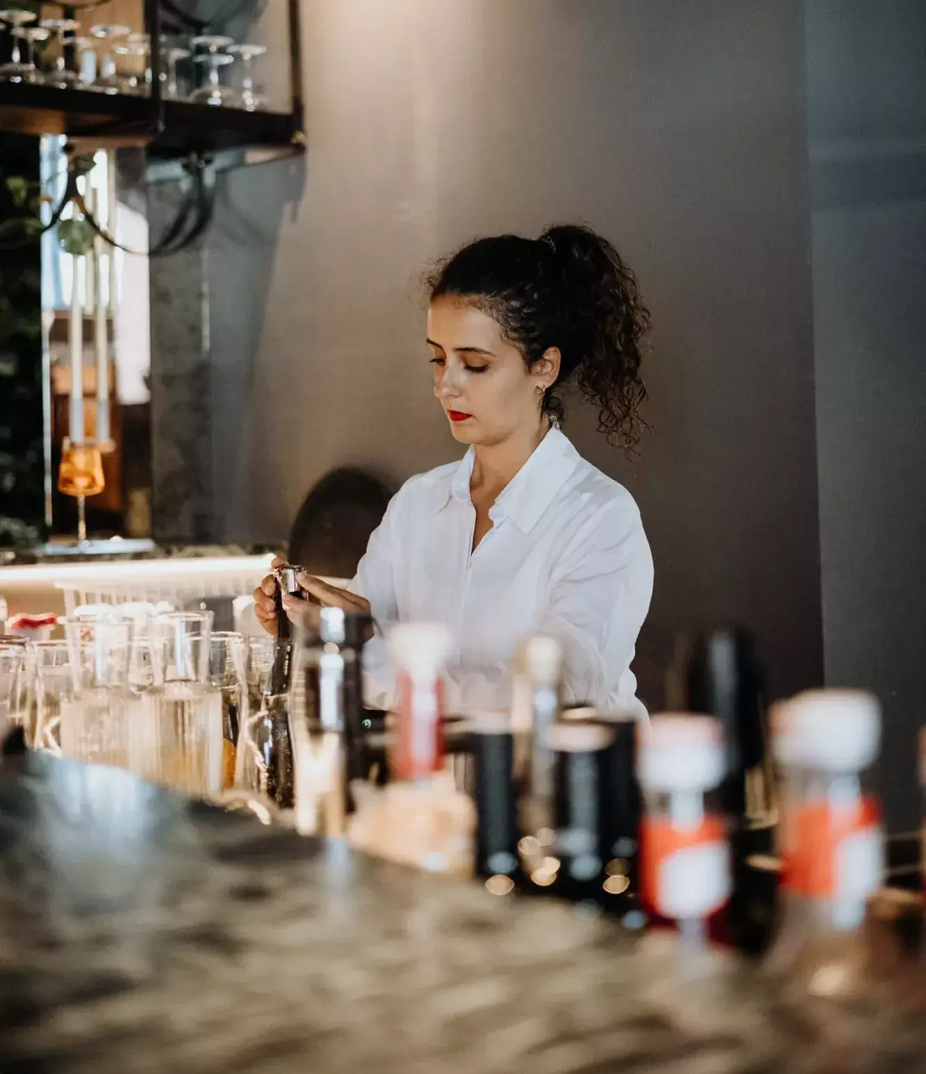 A staff member standing behind the reception desk, assisting guests with a warm and welcoming demeanor.