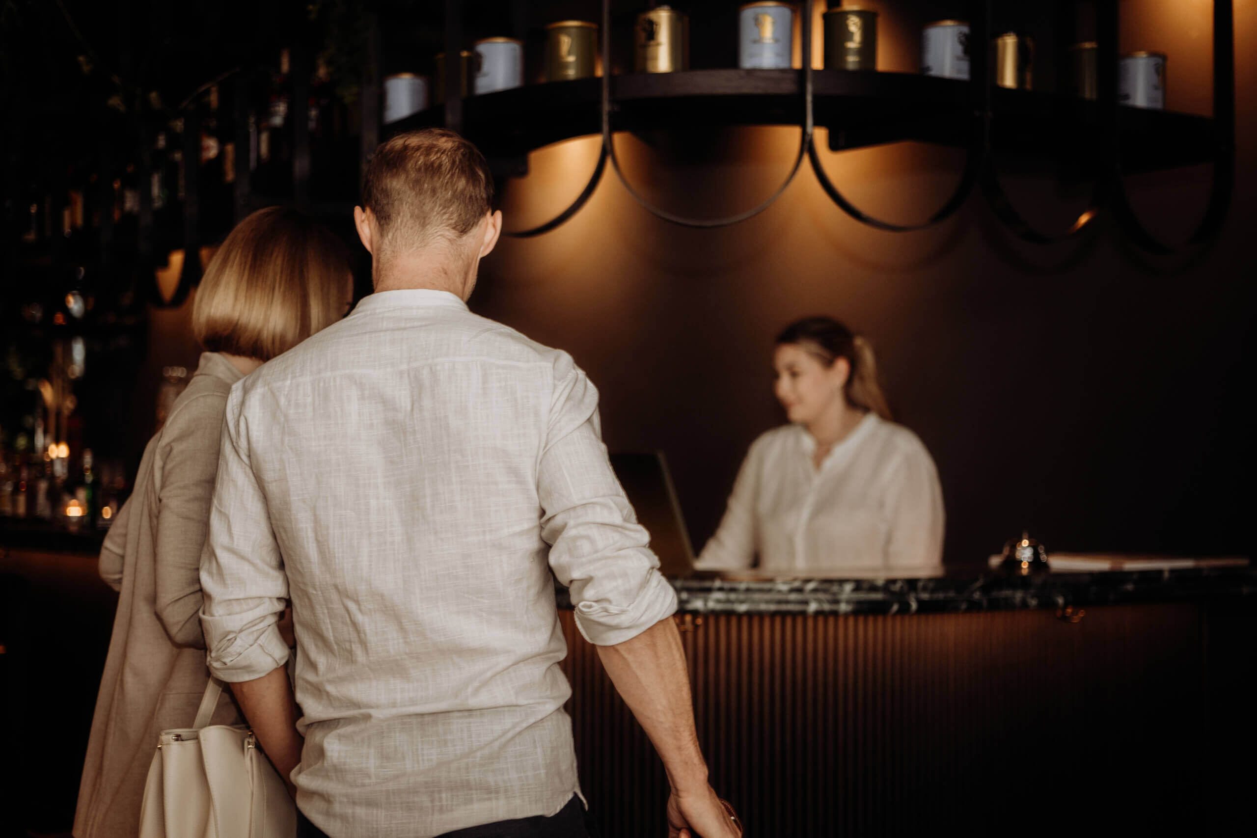 Couple checking in at Gentle Hide Hotel reception desk.