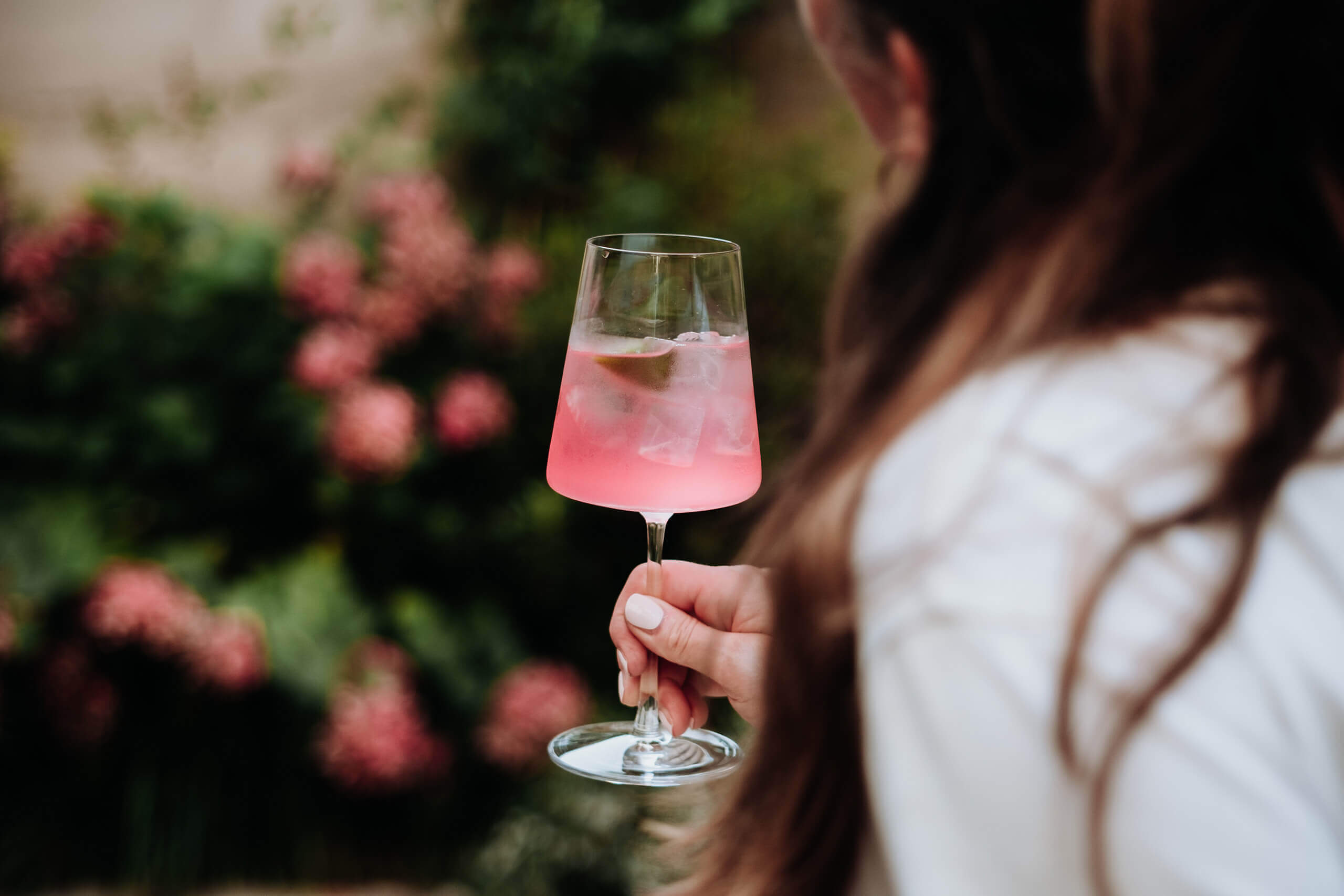 Woman enjoying a pink aperitif cocktail at The Hide Bar during a slow afternoon.