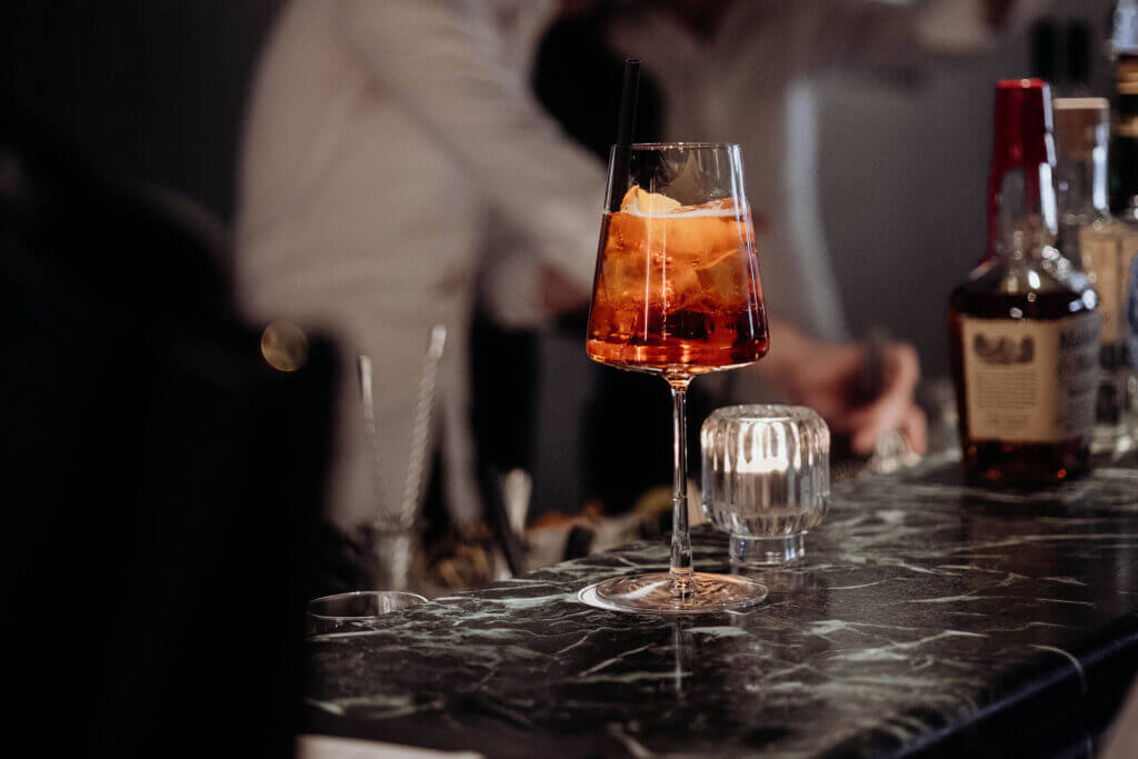 Aperol Spritz in a tall glass on a marble bar at Hide Bar