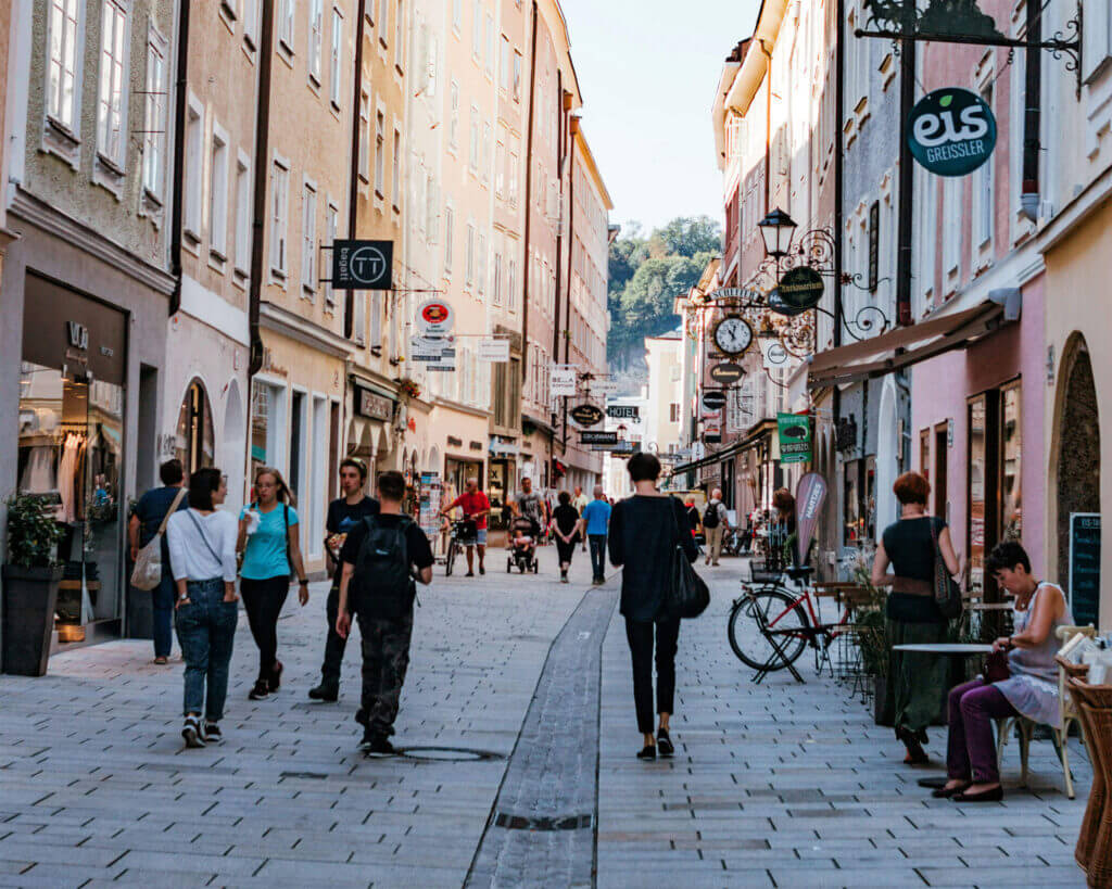 Linzergasse street in Salzburg with shops and people walking