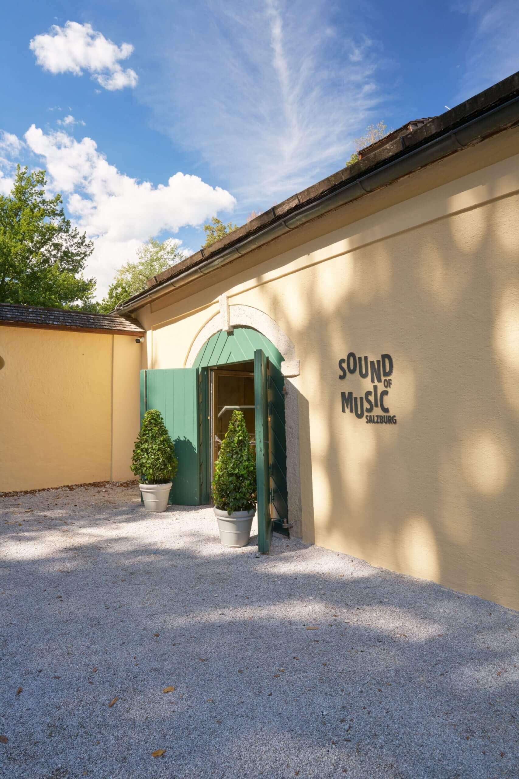 Sound of Music Salzburg building entrance with green doors and topiaries